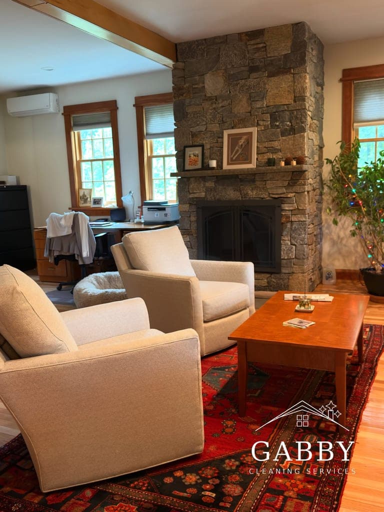 Cozy living room with stone fireplace, freshly cleaned and tidy